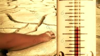 快速上升的温度在温度计上用手刮刮开裂的地面表面